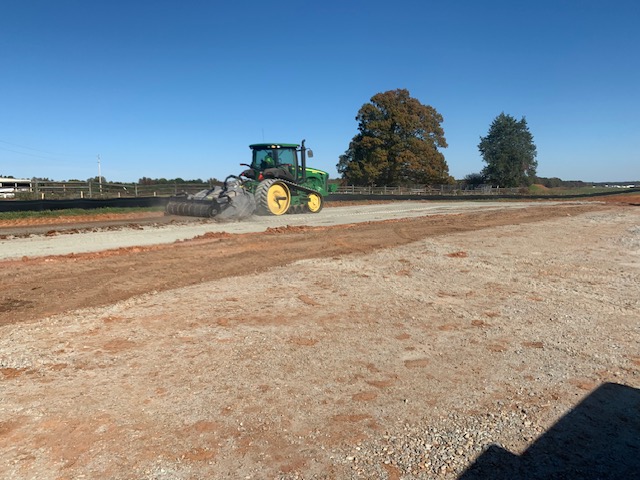 John Deere tractor and soil reclaimer stabilizing an access road
