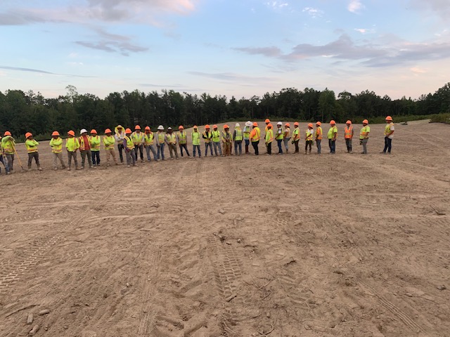 HGS Contracting crew gathered for a safety meeting on a cleared site