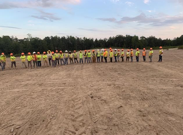 HGS Contracting crew in personal protective equipment during a job-site safety briefing
